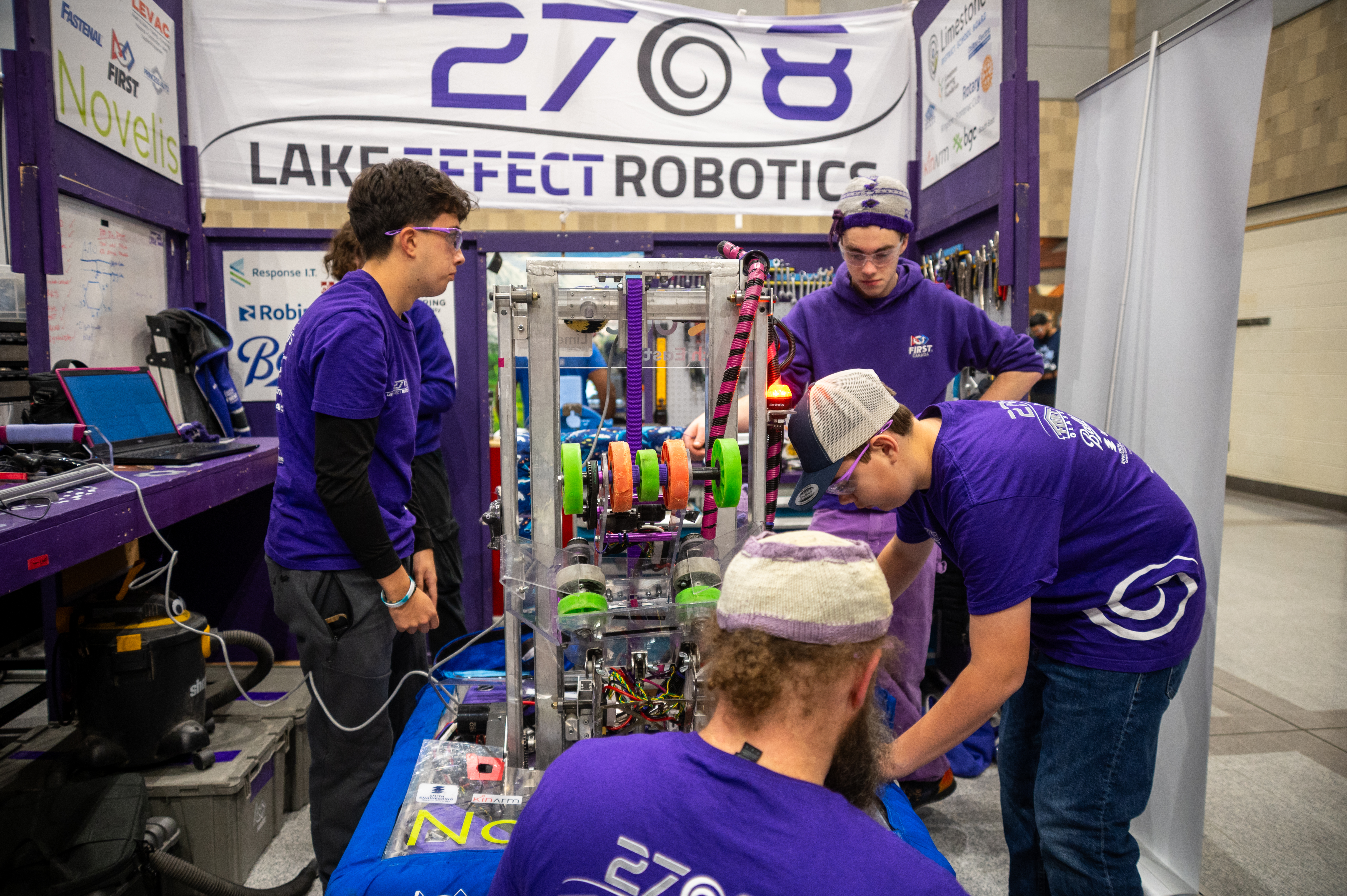 Pit crew fixing the robot